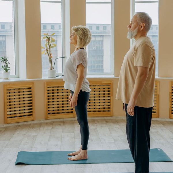 A man focused on his posture during a balance exercise in a calm environment.